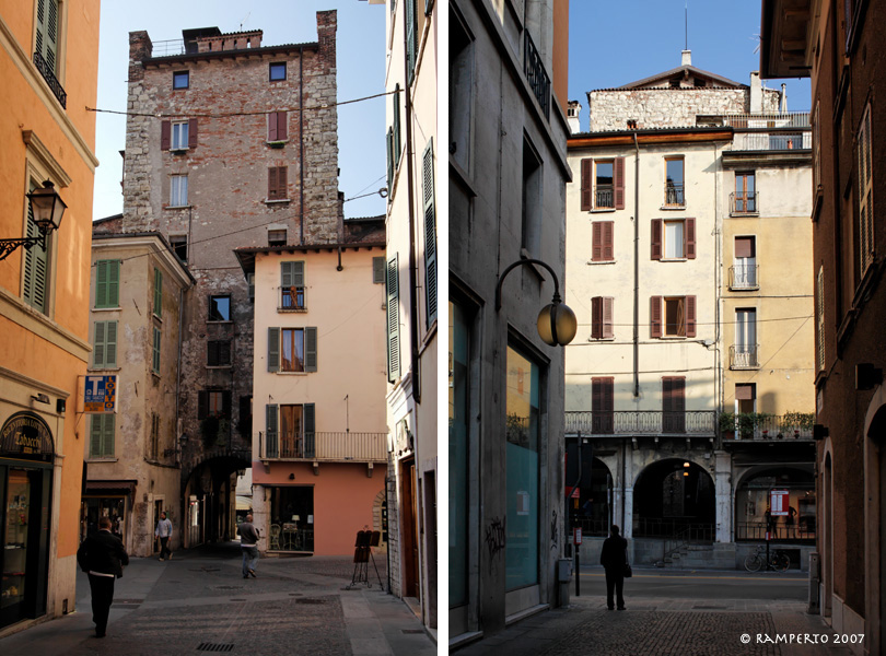 A sinistra: Porta Bruciata vista da Est (via Musei); a destra: Porta Paganora vista da Ovest (via F.lli Dandolo). Sopra le case dei portici si può vedere la sommità della torre.